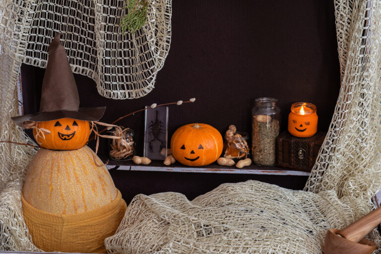 pumpkin with face brown chest against background bottles with potions candles scaled