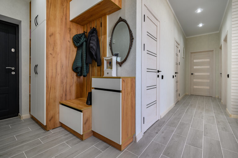 small entrance hallway interior with shoe storage hanger stand mirror scaled