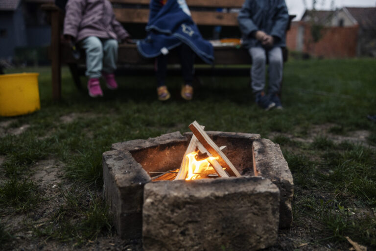 selective focus campfire backyard with children sitting background 1