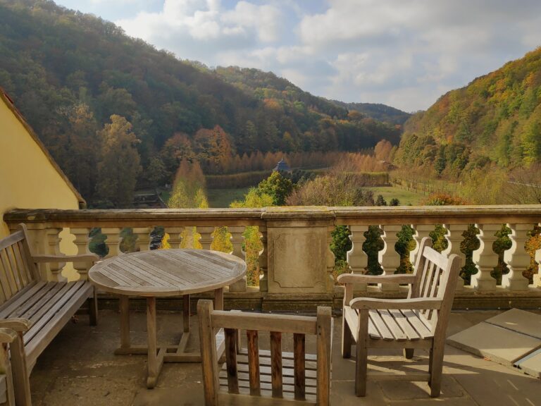 view castle weesenstein with wooden terrace empty chairs tables against cloudy sky